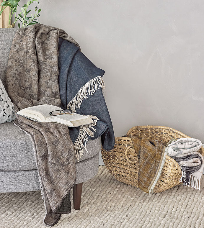 This textured mustard throw, made from 100% cotton, adds a warm, inviting touch to any space. The frayed edge finish gives it a relaxed, stylish look, and it's machine washable for effortless upkeep.